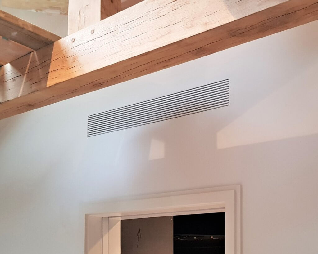 Discreet linear bar grille in wall for hidden air conditioning to a luxury London mews property
