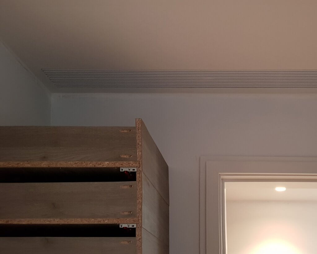 Discreet linear bar grille in ceiling for hidden air conditioning to a luxury London mews property