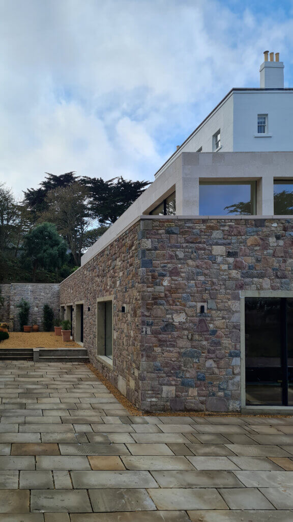 External view of a Channel Islands luxury coastal villa undergoing renovation