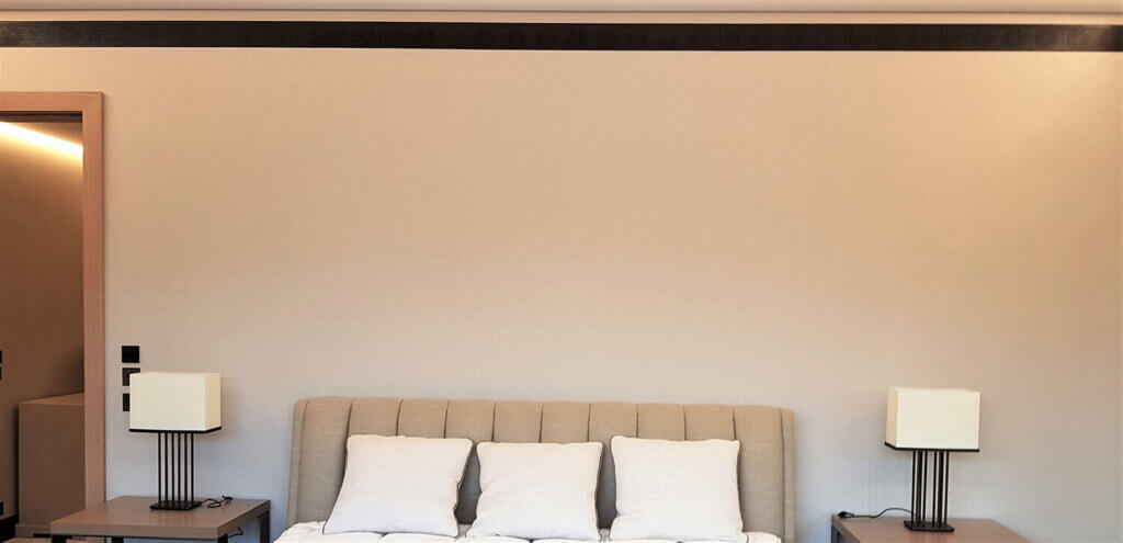 Wall plastered in black linear bar grille in bedroom for air conditioning
