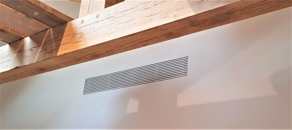Discreet plaster in linear bar grille for air conditioning in a luxury London mews property bedroom
