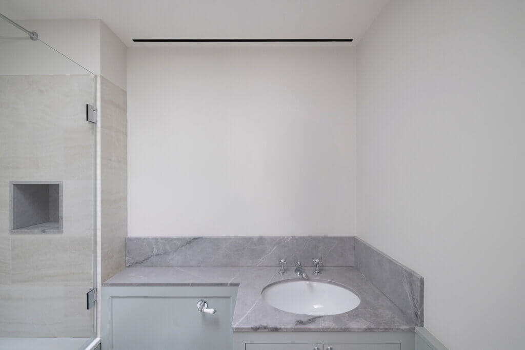 Slim slot in ceiling for bathroom ventilation in a Kensington mansion