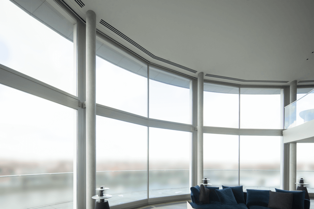 Triple slot diffusers in the ceiling for ventilation and air conditioning to a luxury Battersea penthouse overlooking the Thames