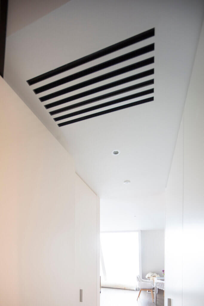 Multi-slot diffuser in the doorway ceiling for ventilation in a Battersea penthouse with views over the Thames
