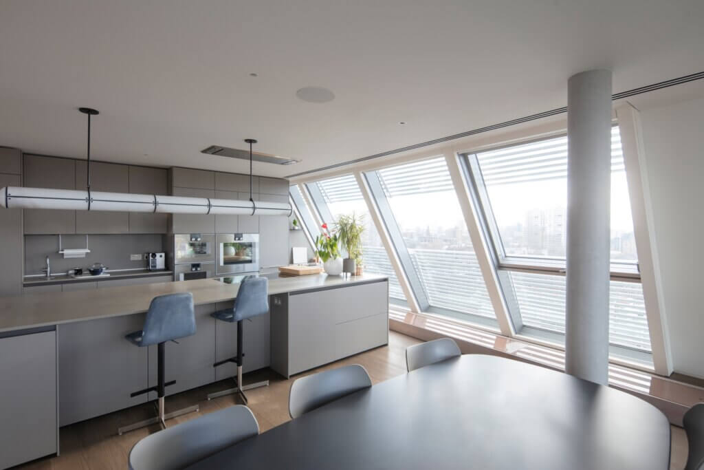 Triple slot diffuser aligned with edge of ceiling in the kitchen for air conditioning and ventilation in a prime Battersea penthouse overlooking the Thames