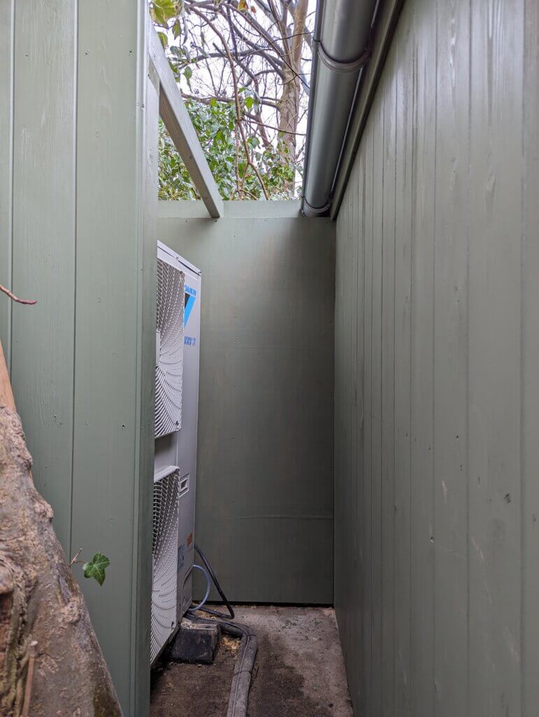 External air conditioning condenser unit concealed in free standing shed to meet planning permission