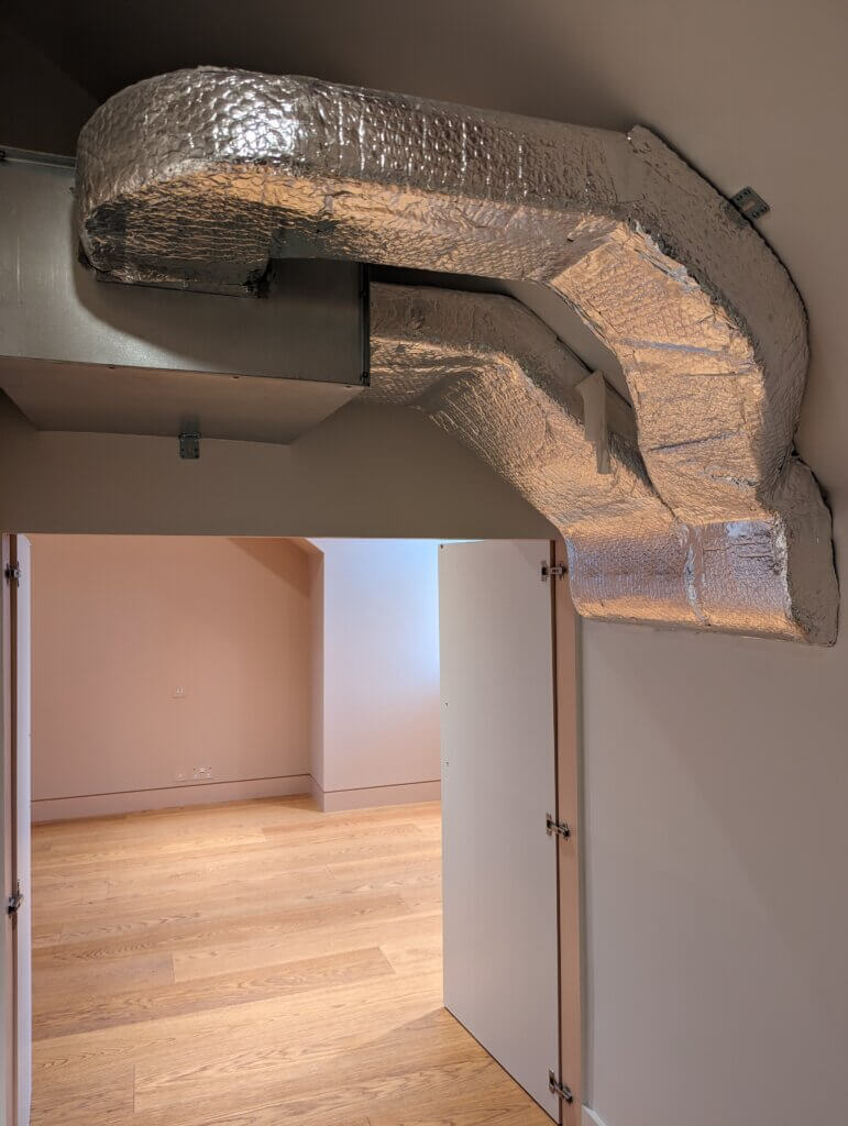 Air conditioning ductwork concealed in the eaves void