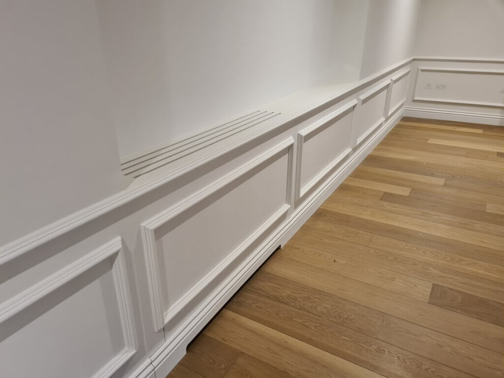 Return air slots for air conditioning in skirting board discreetly in luxury Notting Hill apartment with equipment concealed in low level joinery