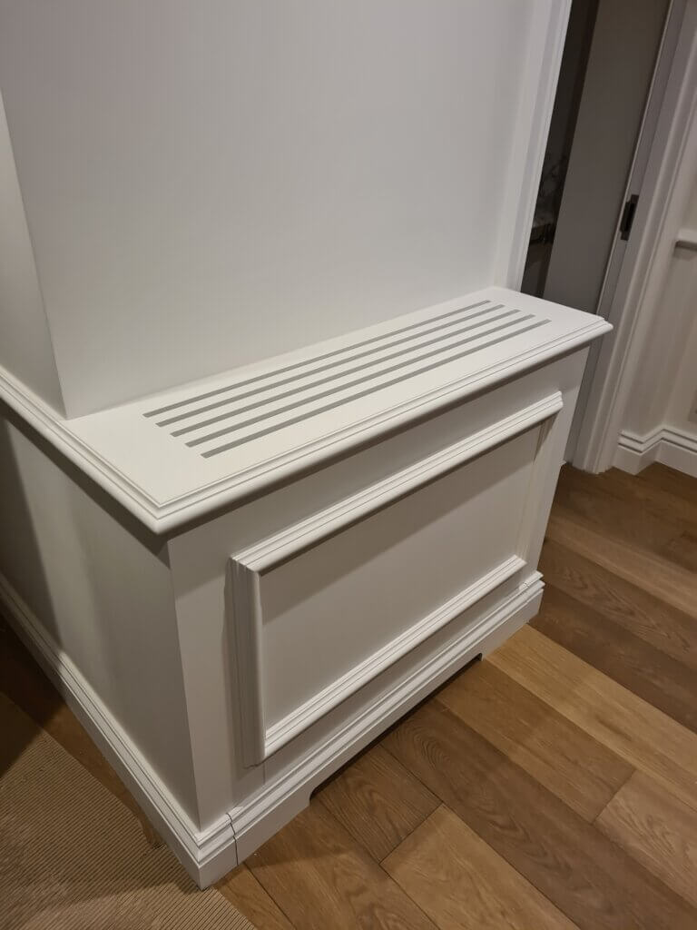 Air conditioning concealed in low-level joinery with slots for supply and return air in a luxury residential London property