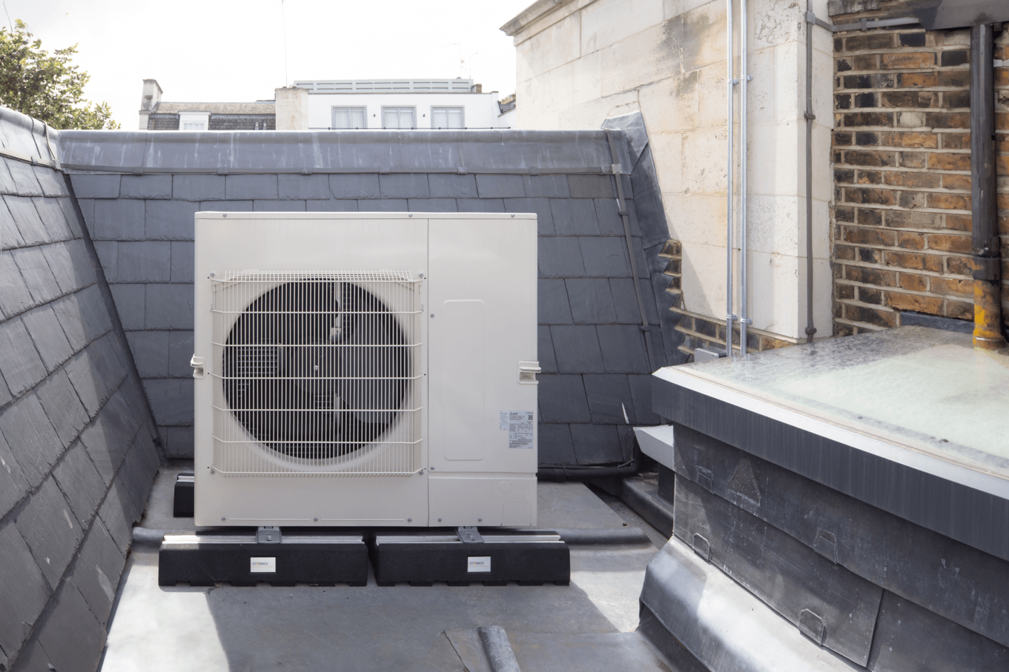 External air conditioning condenser unit hidden in roof recess