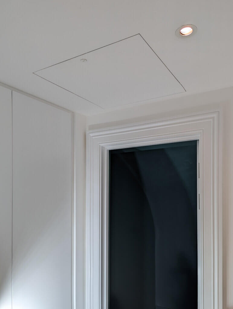 Access hatch to air conditioning fan coil units concealed in the eaves void in a Kensington residence