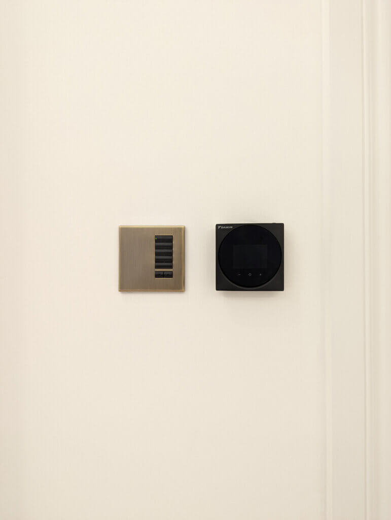 Wall mounted sleek black air conditioning controllers