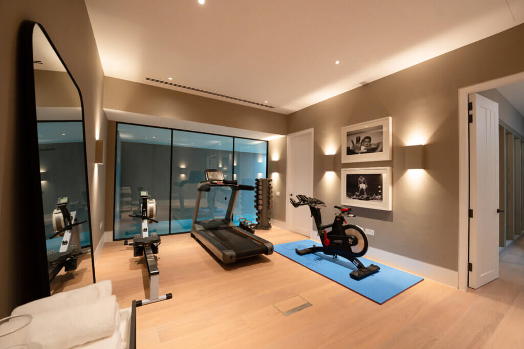 Integrated air conditioning linear twin diffusers and access in a luxury basement gym in Kensington